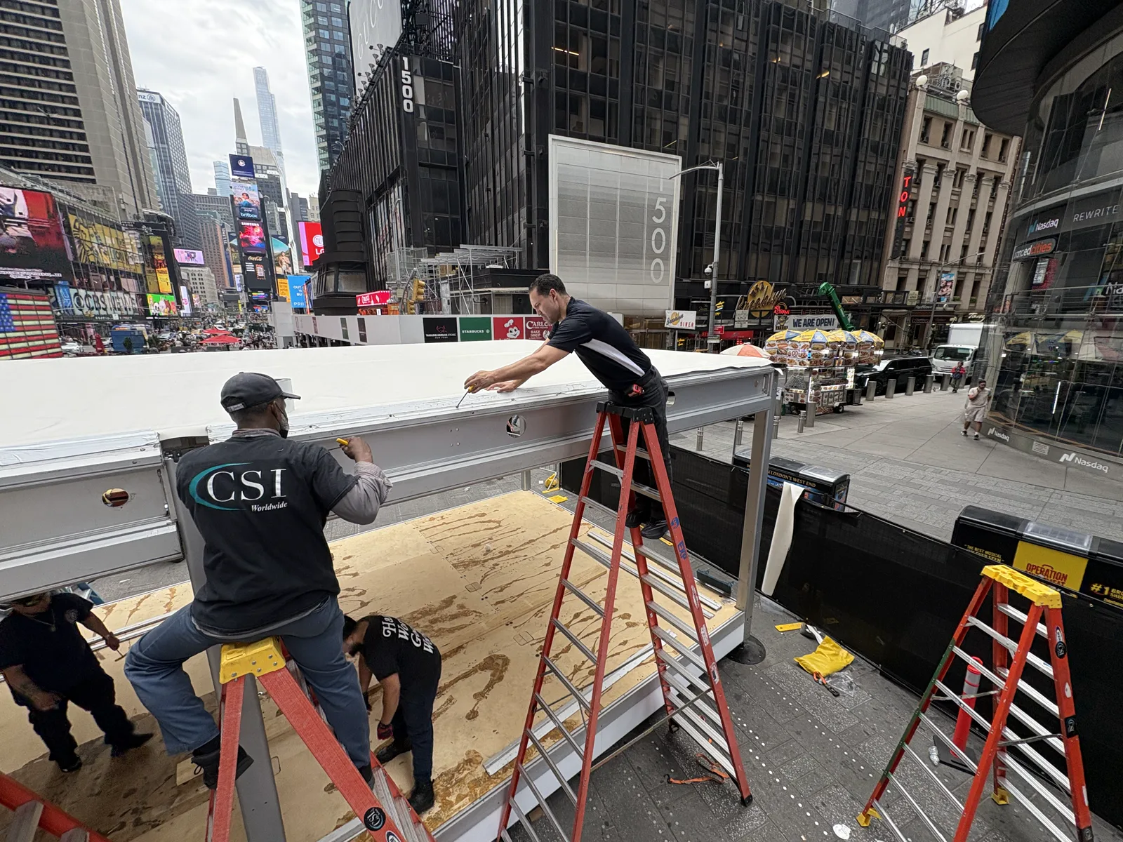 Crew completing roof and structural details on the Times Square activation