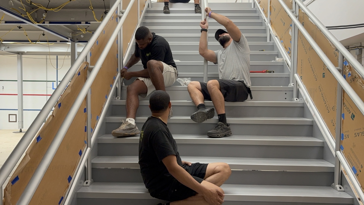 Crew members installing a staircase for the event build