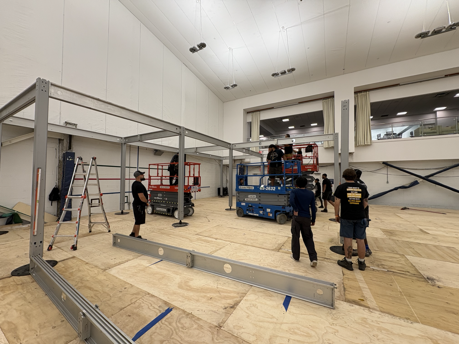 Crew assembling the U.S. Open structure using scissor lifts